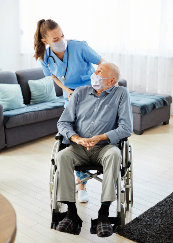 Doctor pushing patient in a wheelchair
